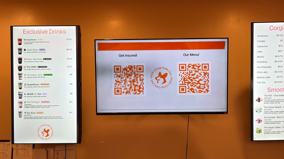 The menu and insurance QR codes behind Corgi Cafe's counter. Photo by EO.